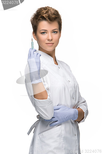 Image of Portrait of lady surgeon showing syringe 