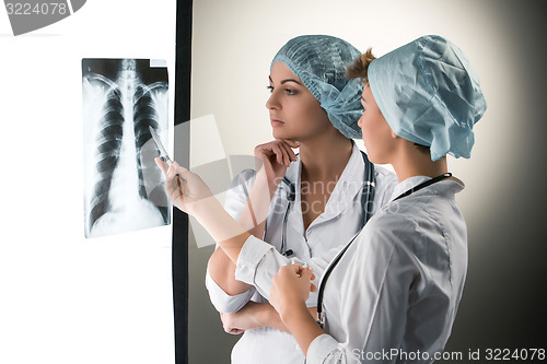 Image of Two attractive young doctors looking at x-ray results