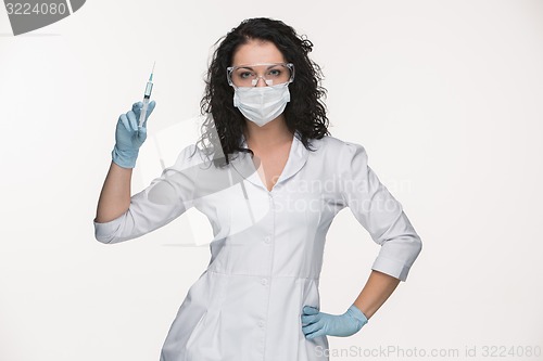 Image of Portrait of lady surgeon showing syringe over white background