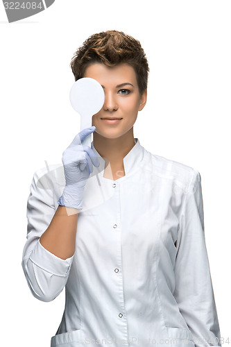 Image of Optometry concept - pretty young woman closes eye