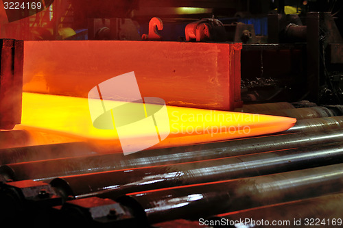 Image of hot steel plate on conveyor