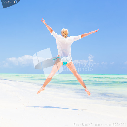 Image of Beautiful Girl Jumping on Tropical Beach.