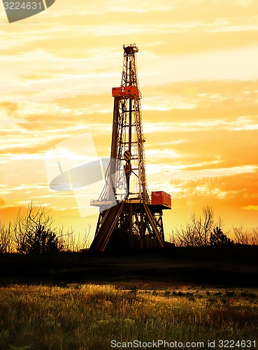 Image of Drilling rig at sunset