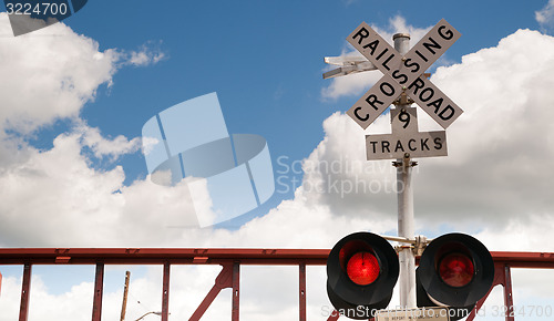 Image of Train Passing Railroad Crossing Warning Lights Flashing