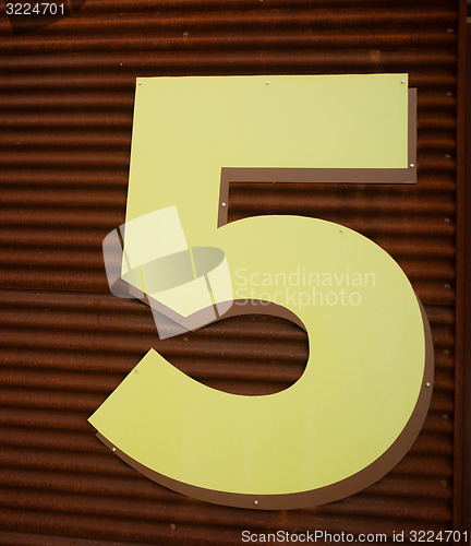 Image of Number 5 Five Fifth Floor Parking Garage Yellow Rusted Wall