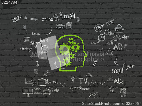 Image of Marketing concept: Head With Gears on wall background