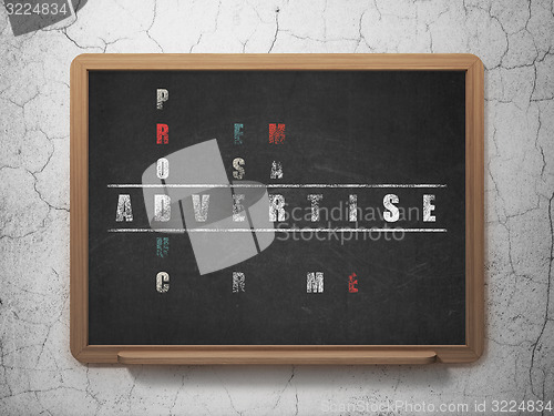 Image of Marketing concept: word Advertise in solving Crossword Puzzle
