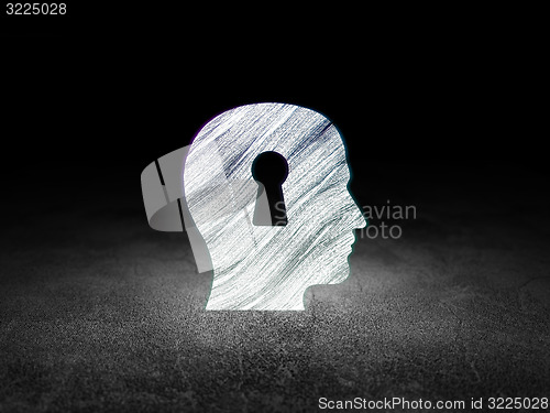 Image of Finance concept: Head With Keyhole in grunge dark room