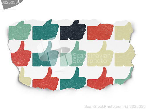 Image of Social media concept: Thumb Up icons on Torn Paper background