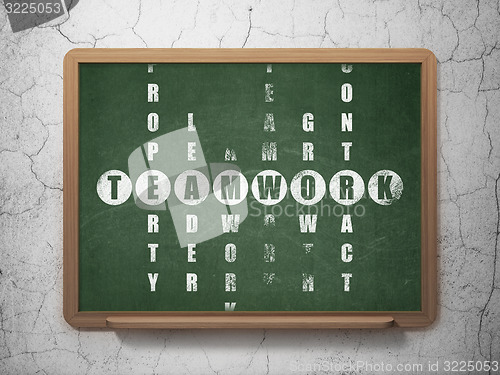 Image of Finance concept: word Teamwork in solving Crossword Puzzle