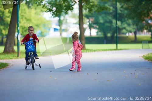 Image of boy and girl with bicycle