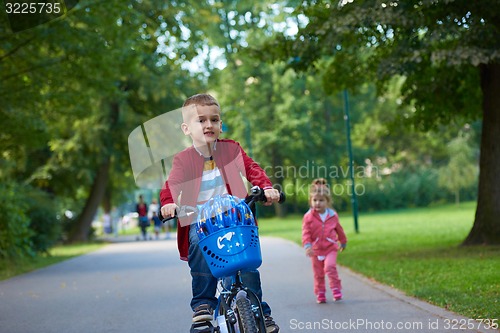 Image of boy and girl with bicycle