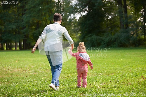 Image of happy family playing together outdoor in park