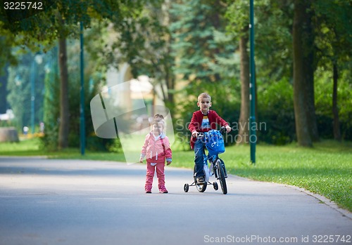 Image of boy and girl with bicycle