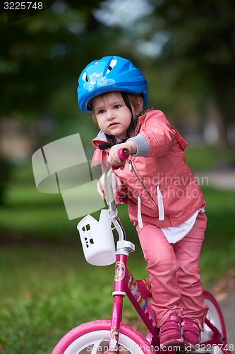 Image of little girl with bicycle