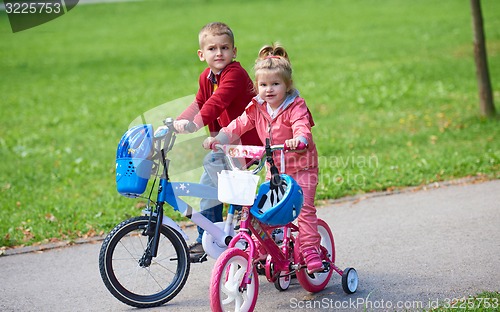 Image of boy and girl with bicycle