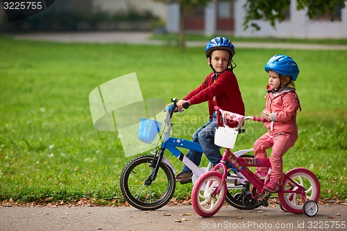 Image of boy and girl with bicycle