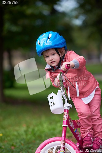 Image of little girl with bicycle