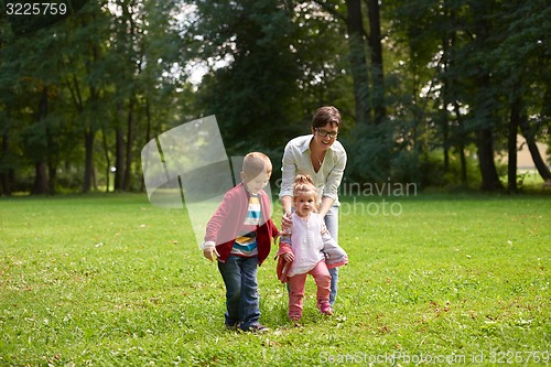 Image of happy family playing together outdoor in park