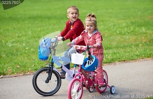 Image of boy and girl with bicycle