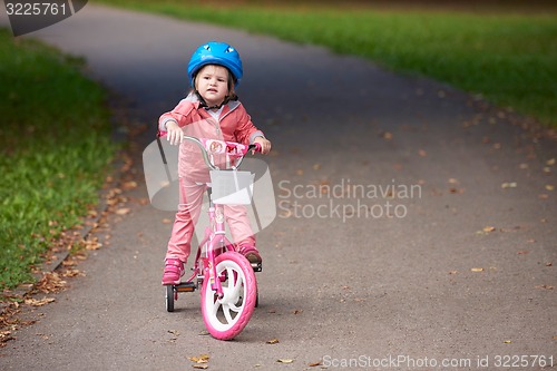 Image of little girl with bicycle