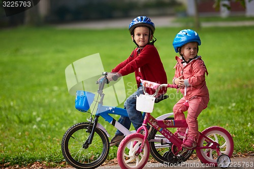 Image of boy and girl with bicycle