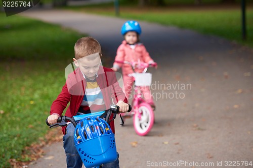 Image of boy and girl with bicycle