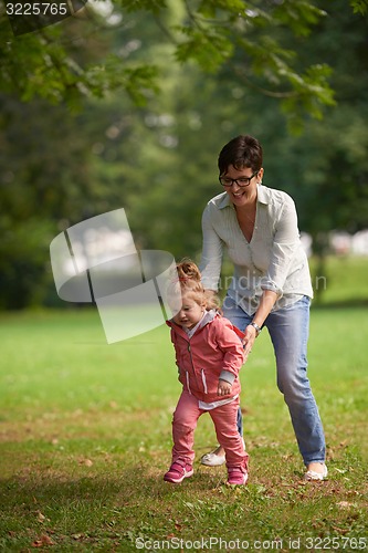 Image of happy family playing together outdoor in park