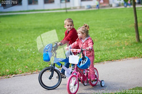 Image of boy and girl with bicycle