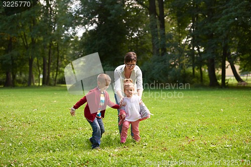 Image of happy family playing together outdoor in park