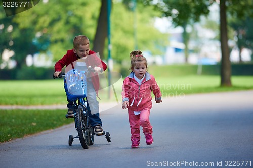 Image of boy and girl with bicycle