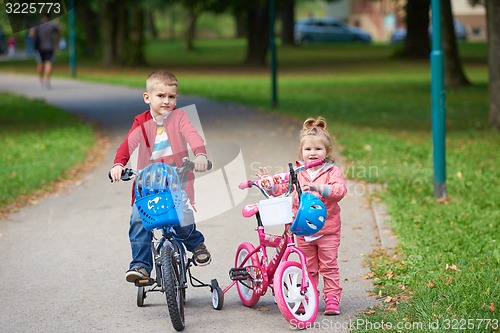 Image of boy and girl with bicycle