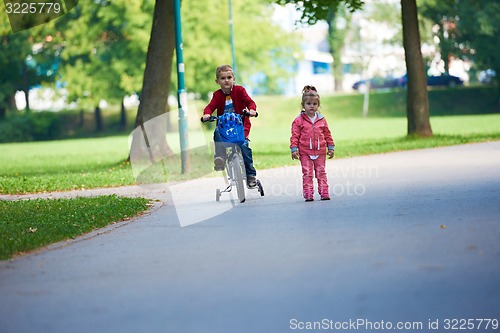 Image of boy and girl with bicycle