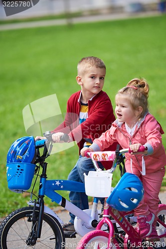 Image of boy and girl with bicycle