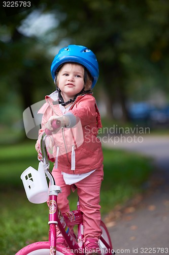 Image of little girl with bicycle