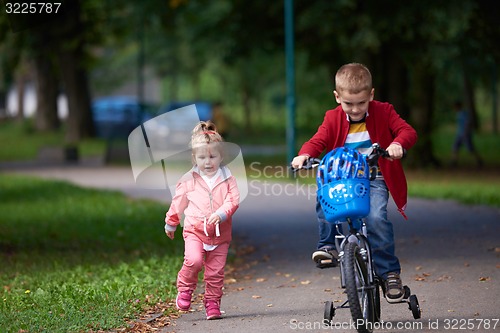 Image of boy and girl with bicycle