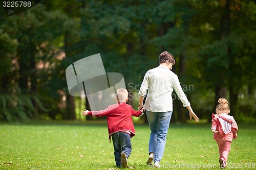 Image of happy family playing together outdoor in park