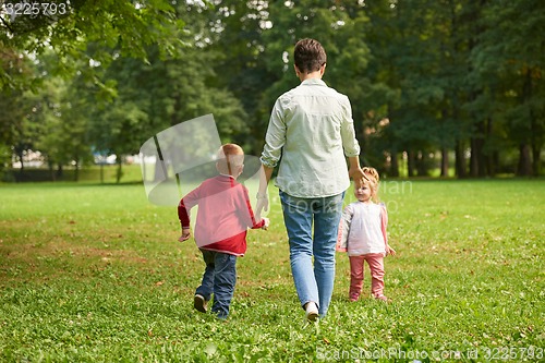 Image of happy family playing together outdoor in park