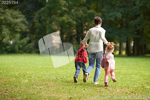 Image of happy family playing together outdoor in park