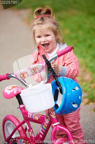 Image of little girl with bicycle