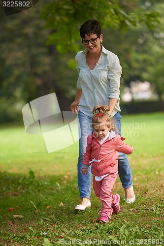 Image of happy family playing together outdoor in park