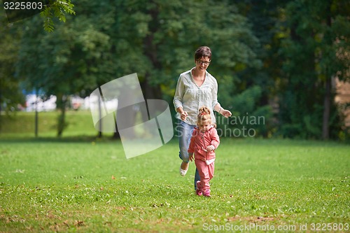 Image of happy family playing together outdoor in park