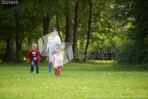 Image of happy family playing together outdoor in park