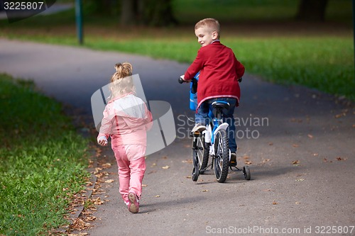 Image of boy and girl with bicycle