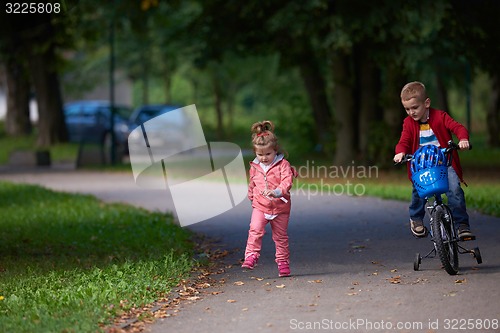 Image of boy and girl with bicycle