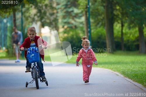 Image of boy and girl with bicycle