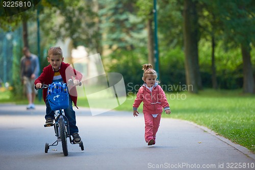 Image of boy and girl with bicycle