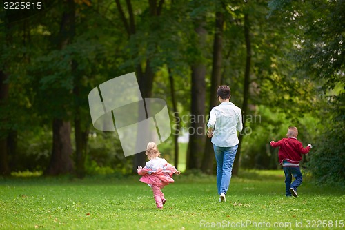 Image of happy family playing together outdoor in park