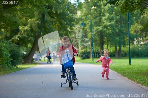 Image of boy and girl with bicycle