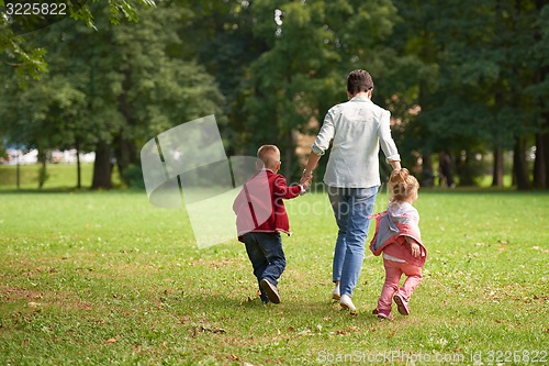 Image of happy family playing together outdoor in park